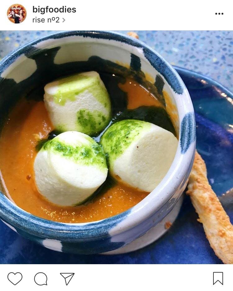 Tomato basil soup topped with mini goat cheese soufflés from rise no2.