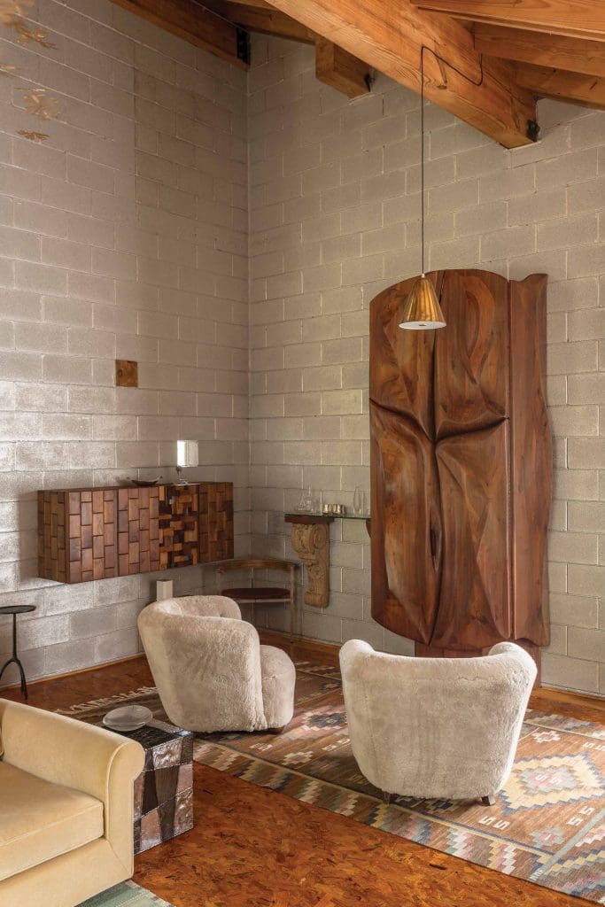 Greatest hits from the mid-20th century onward: Paul Evans Argente cube, chairs by a Danish cabinet maker, Paavo Tynell hanging light, Marta Maas-Fjetterstrom carpet, and Phillip Lloyd Powell bar and wall-mounted cabinet.
