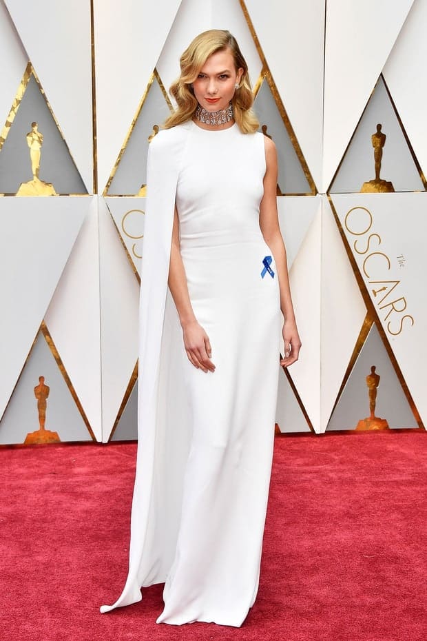 Stella McCartney dress, Nirav Modi jewelry, and carrying a Roger Vivier clutch