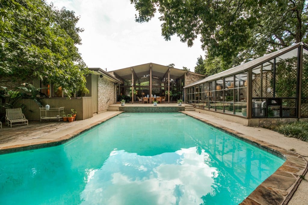 The 1966 house was designed by architect Lyle Rowley. The working greenhouse was originally built for orchids.