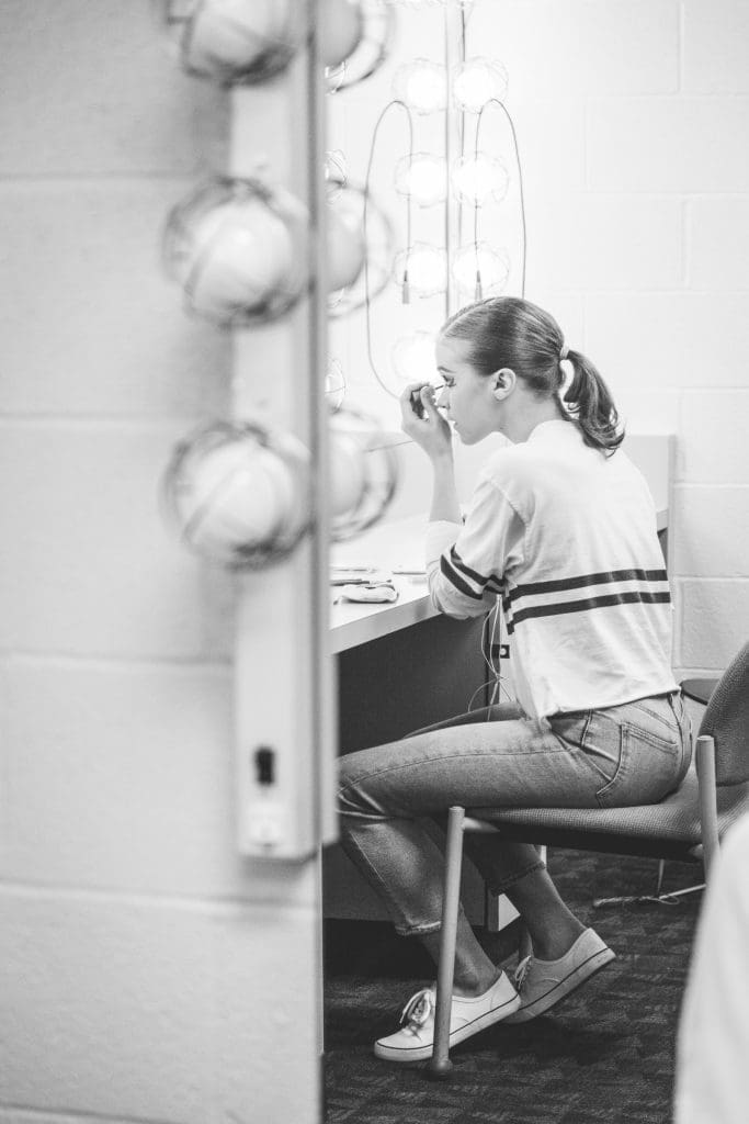 Bridget Kuhns starts preparing in the dressing room.