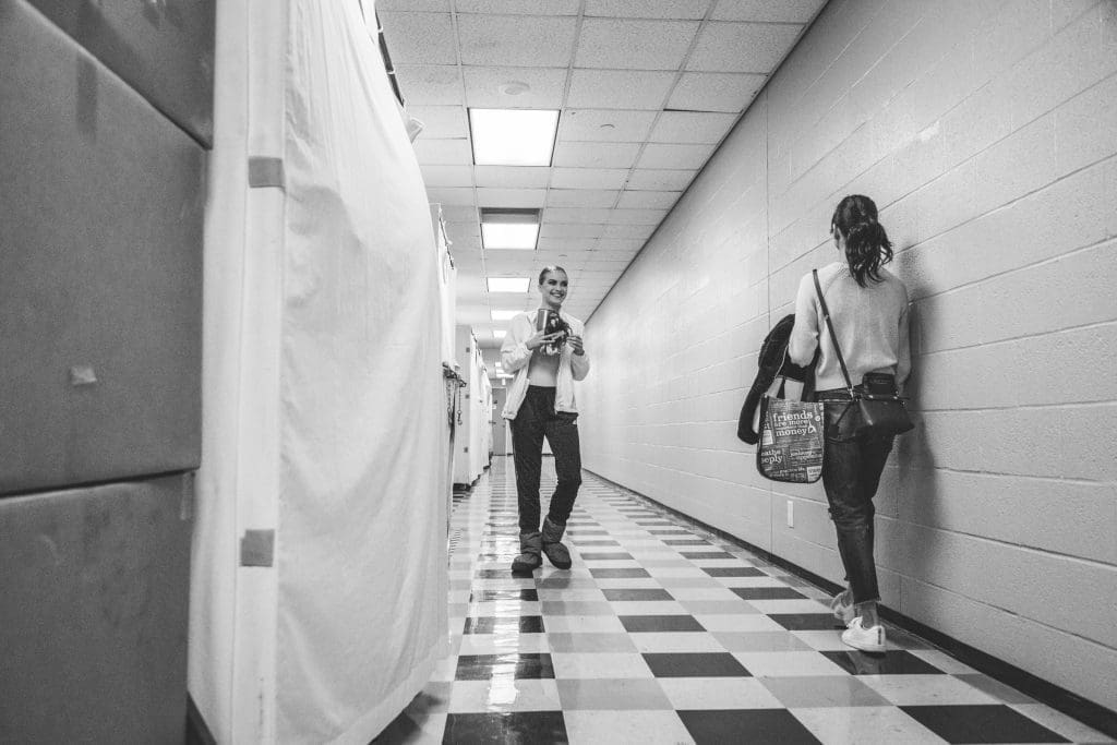 Bridget Kuhns greets another dancer in the halls.