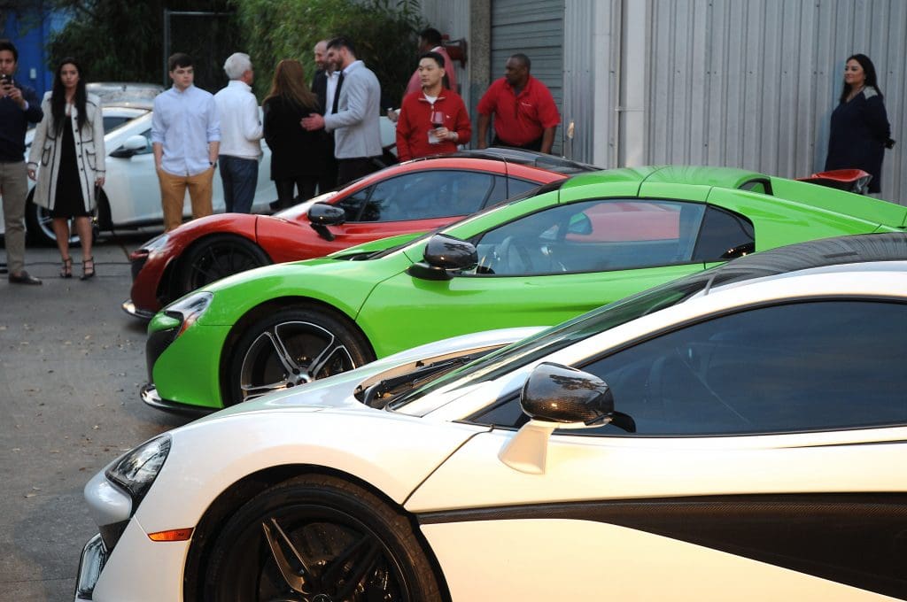 Guests look over the vehicles at the McLaren Houston unveiling party for the new McLaren 720s at 5226 Elm Thursday March 16,2017. (Dave Rossman Photo)