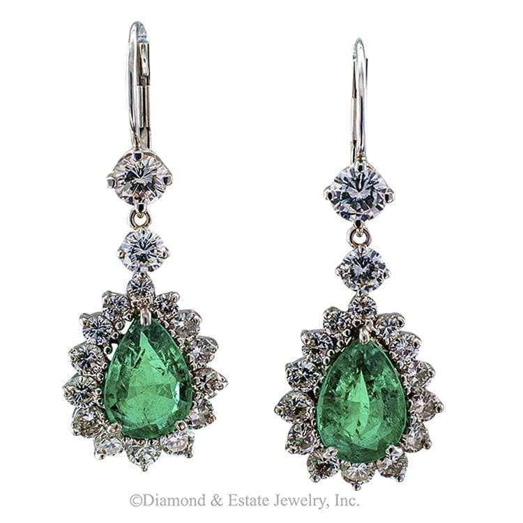Exhibitor Jacobs Diamond Estate Jewelry of Los Angeles showing a 1970s Pear-shaped Colombian Emerald and Diamond Pendant Earrings
Pendent earrings comprising approximately 3.50 carats of pear-shaped Columbian emeralds and approximately 2.40 carats of round brilliant-cut diamonds approximately F, G, H color and VS clarity, mounted in 18-karat white gold, circa 1970.  The pear-shaped emeralds are beautifully matched, vibrant, resplendent with that irrisitible shade of green that is so unique to emeralds from Colombia.  There is movement as they dance with the slightest movement of the head, and then there is glitter, sparkle and flashes of green all over the place.  It is a very pretty light show... elegant and rich...everything tastefully proportioned... a fine pair of emerald and diamond earrings!
DIMENSIONS:  1 3/8" long and 1/2" wide overall.