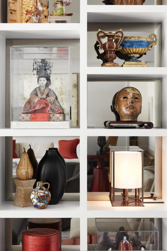 Custom cabinets hold treasures from travels and the couple’s collections, such as an Edo-period Japanese doll, Portuguese pottery head, antique vessels from Rome and Paris.