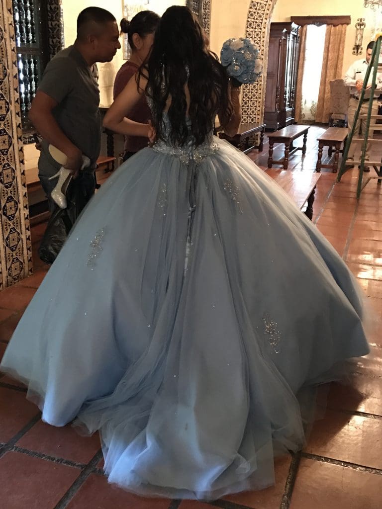 A young girl is preparing for her quinceañera photo shoot in Quinta Mazatlan's Grand Hall.