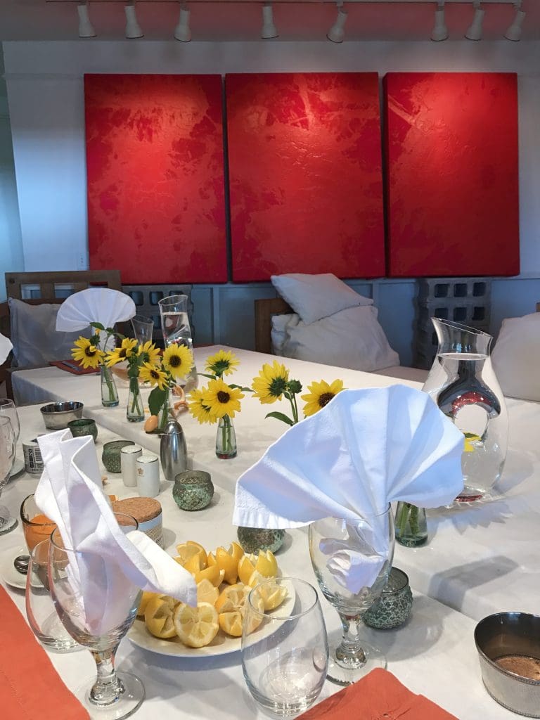 We are enveloped by Michael Tracy's fiery red paintings as the table was set for lunch and conversation.