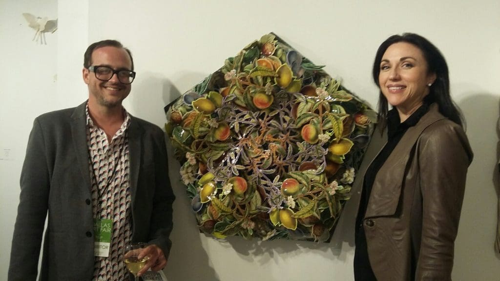 Patrick Turk and Cris Worley with Turk's "Eastern Garden," 2016, an exuberant, obsessive collage, at Cris Worley Fine Arts. 