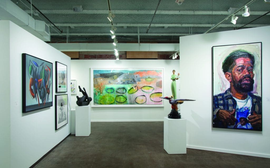 Valley House Gallery's booth was punctuated by a Valton Tyler canvas (left) and a Sedrick Huckaby portrait (right), two Texas talents in their stable that always draw interest. 