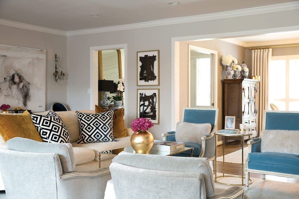 In the living room, an oversized painting by Saba Jawda. David Hicks La Fiorentina and mustard velvet pillows. Sets of inherited reupholstered chairs.