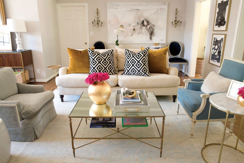 In the living room, an oversized painting by Saba Jawda. David Hicks La Fiorentina and mustard velvet pillows. Sets of inherited reupholstered chairs.