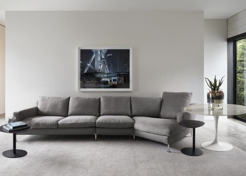 In the seating area across from the kitchen, B&B Italia
Harry sectional, BluDot Swole end tables, and white marble Knoll table by Eero Saarinen. Mike Osborne’s "Enter the Dragon," 2006, from Holly Johnson Gallery.