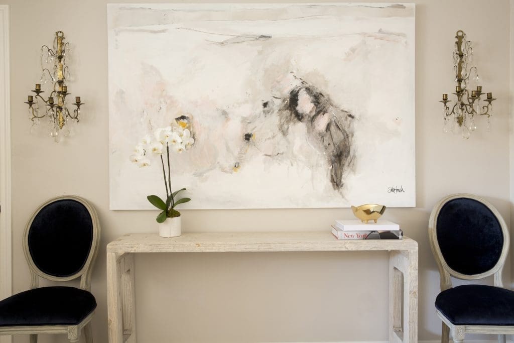 An oversized painting by Saba Jawda in the living room.