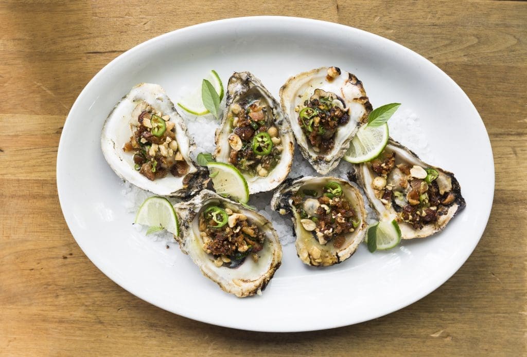 Underbelly's grilled Texas oysters raise the bar with pork belly, peanuts, and green onion. 