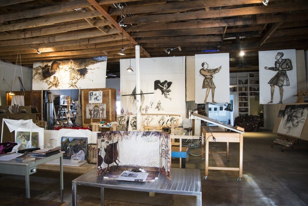The building across from 100 West was originally a grocery store from 1924 built by L.T. Davis, the founder of Wolf Chili, which got its start in Corsicana. It is now used as the studio for Nancy Rebal and a writer's retreat for her husband, essayist David Searcy.