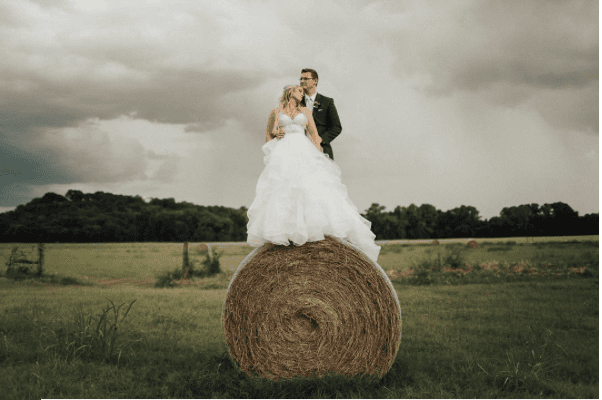 Lindsey & Corbin Sitzes on the grounds of The Brooks in historic Weatherford, Texas, where they were wed in 2017. "Although this shot may have resulted in my husband ripping my wedding dress, I would say it was totally WORTH IT," she told PaperCity. 