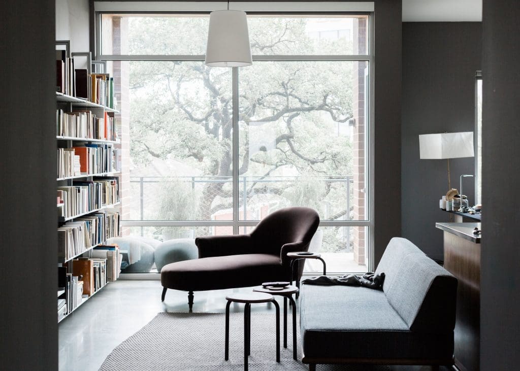 In the library/living room, a George Nelson daybed by Herman Miller, Napoleon III méridienne covered in brown velvet, custom aluminum bookcases by Modern Shelving, and Marcel Wanders for Moooi lamp. Middleton moved into the Mirabeau B., a sustainable apartment building developed by Joey Romano, in the summer of 2014, after living at the modernist Parc IV on Montrose Boulevard during the beginning years of developing his book.