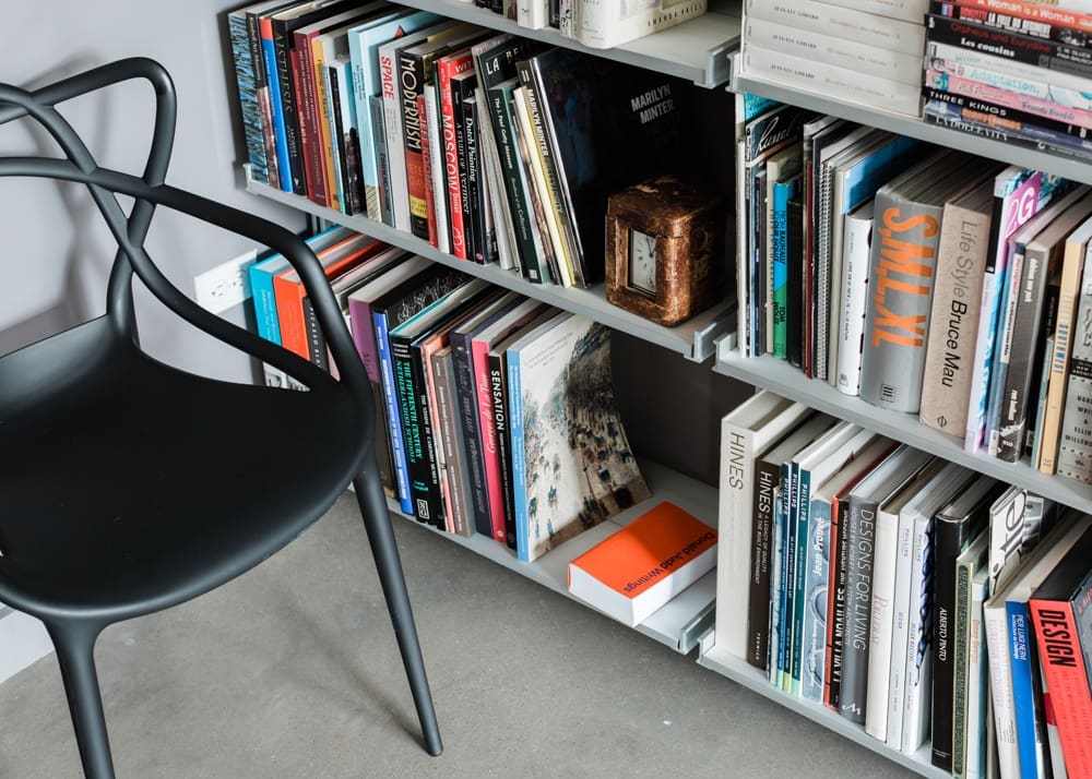Close-up of the custom Modern Shelving bookcases, and a Starck Masters chair from Kartell. The author’s working library boasts 3,000 books — “moving into the apartment required 35 book boxes,” he recalls. 