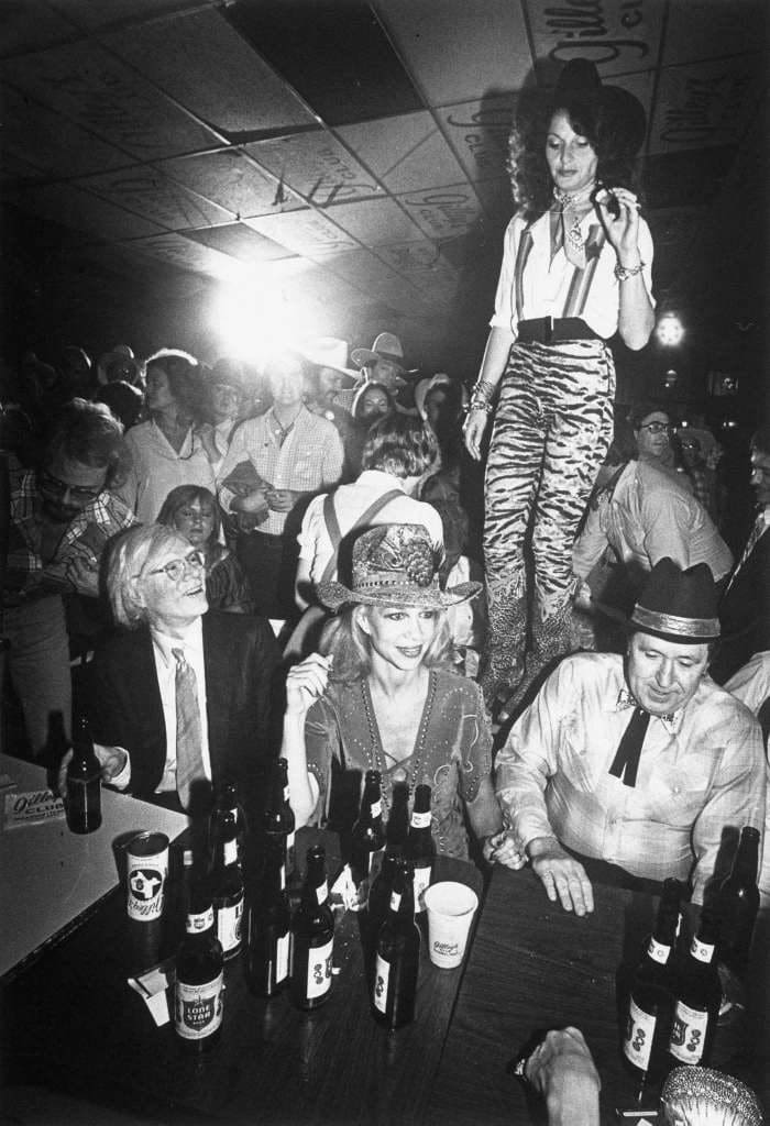Andy Warhol, Lynn & Oscar Wyatt, and Diane Von Furstenberg get down at Gilley's to celebrate the release of "Urban Cowboy," 1980. (Photo John Van Beekum)
