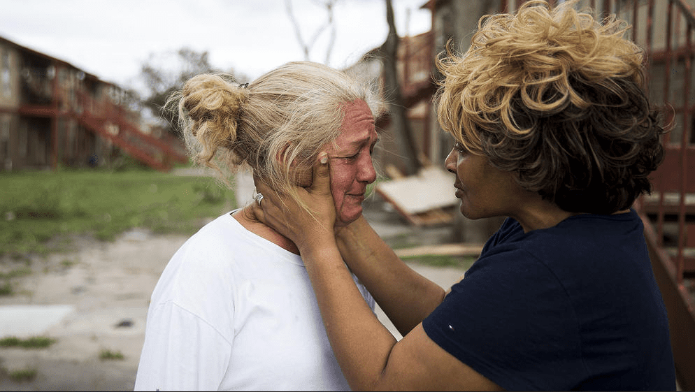 Lifelong friends comfort each other in Refugio, Texas. (Photo by Nick Wagner / Austin American-Statesman via AP) 