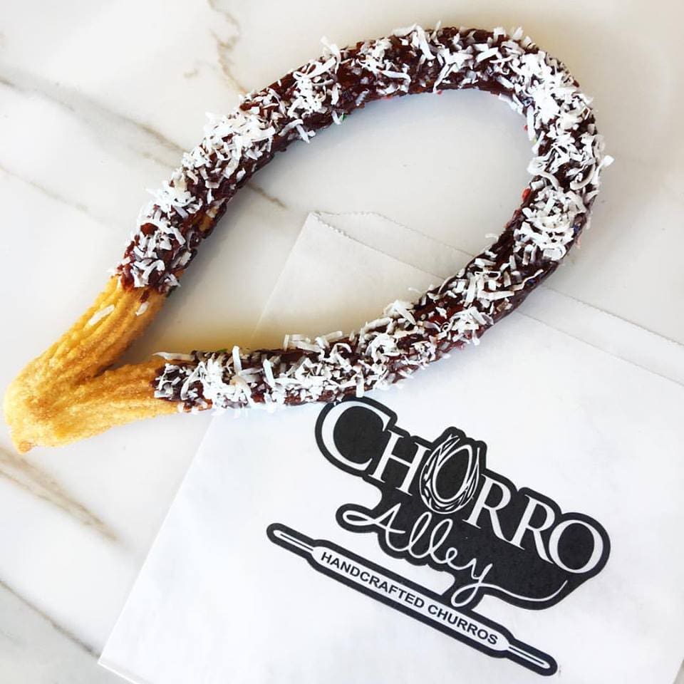 The oval-shaped churros are dunked into cups of creamy soft serve. 