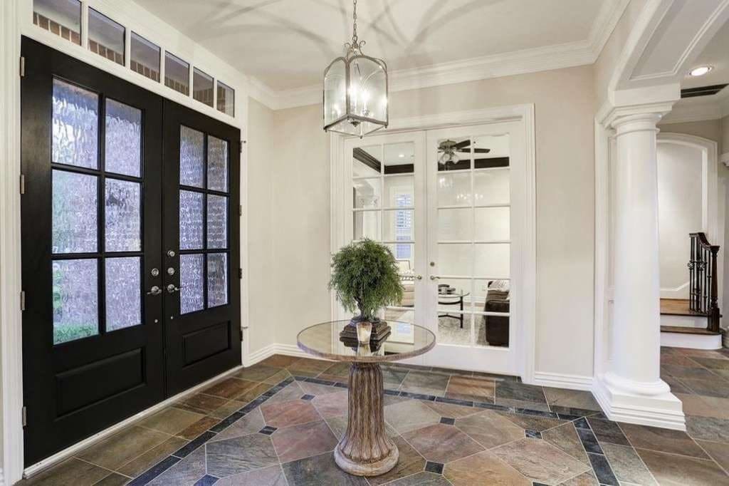 Tom Herman knew he needed a house that could entertain an entire football team. This more modest Bellaire house entryway would no longer do.