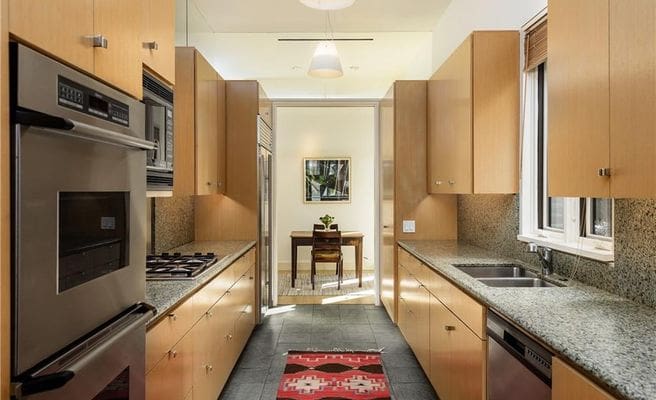 The galley-style kitchen leads to a breakfast nook. 