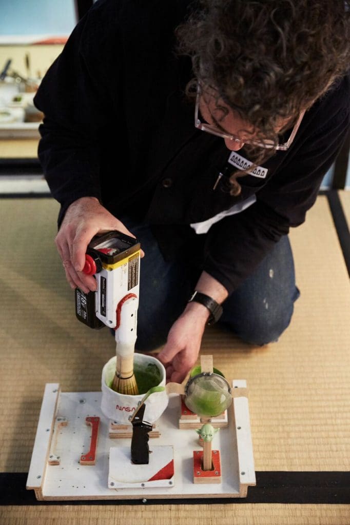 Tom Sachs performing a tea ceremony in his installation.