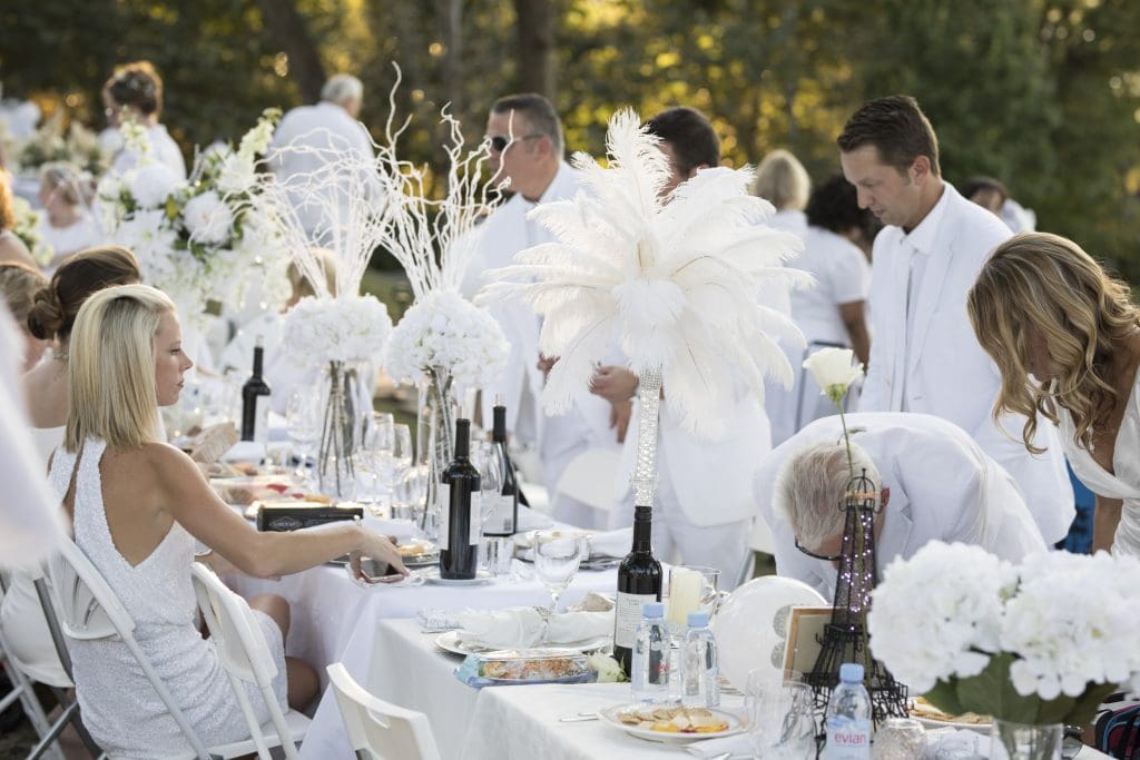 Crafty guests create ornate, white tablescapes for the party. 