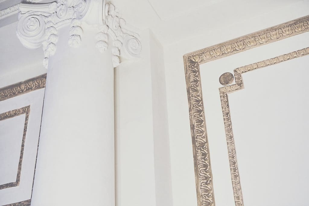 The walls, previously colorful and cherub-covered, have been given a fresh coat of white plaster. 