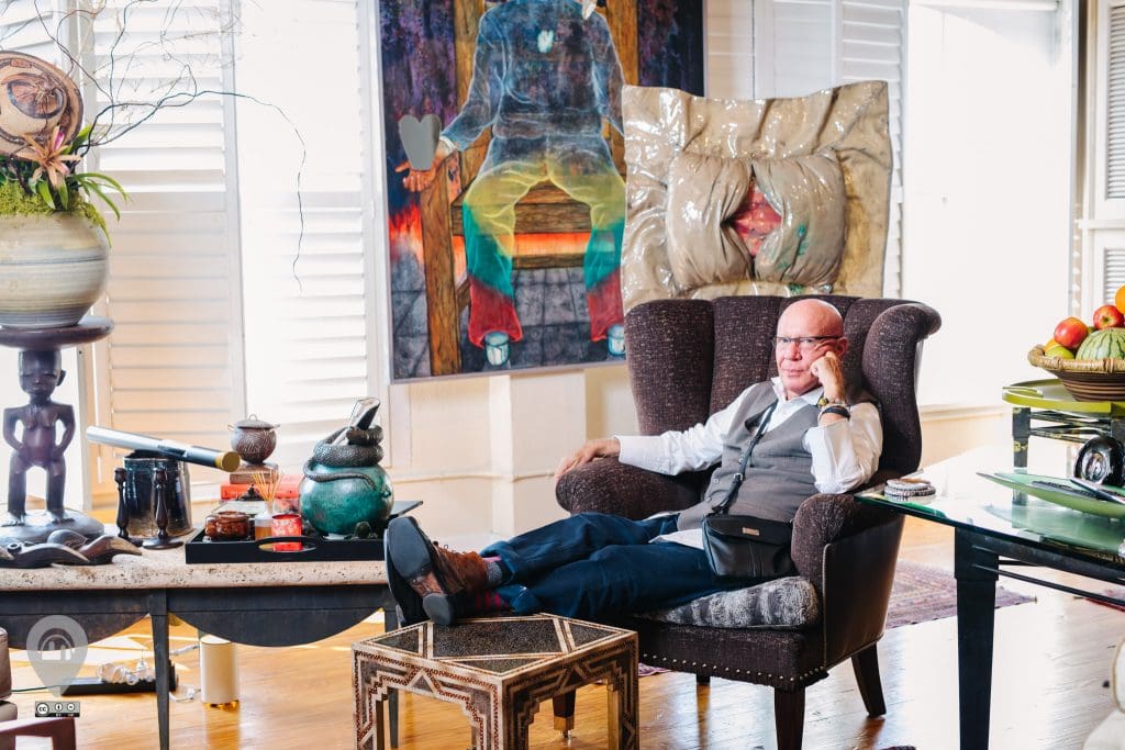 Furniture designer Kelly Gale Amen perches happily in his KGA Compound. 