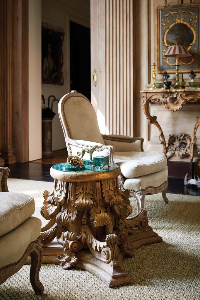 Carved pedestal table from an Antebellum capital in New Orleans, with faux-malachite top. 