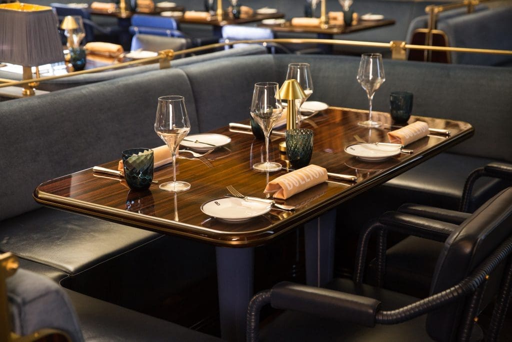 Tables are set with Christofle tableware, The Citizenry clay pottery, and Bernardaud dinnerware.