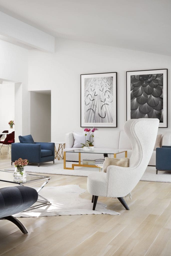 In the living room, Kai & Sunny’s Sycamore Seed, 2013, and Wild Flower, 2013. S&L Designs gold coffee table. Oly Studio George antique gold side table. Blue Minotti armchairs. Tom Dixon wingback chair in Holly Hunt Great Outdoors fabric.