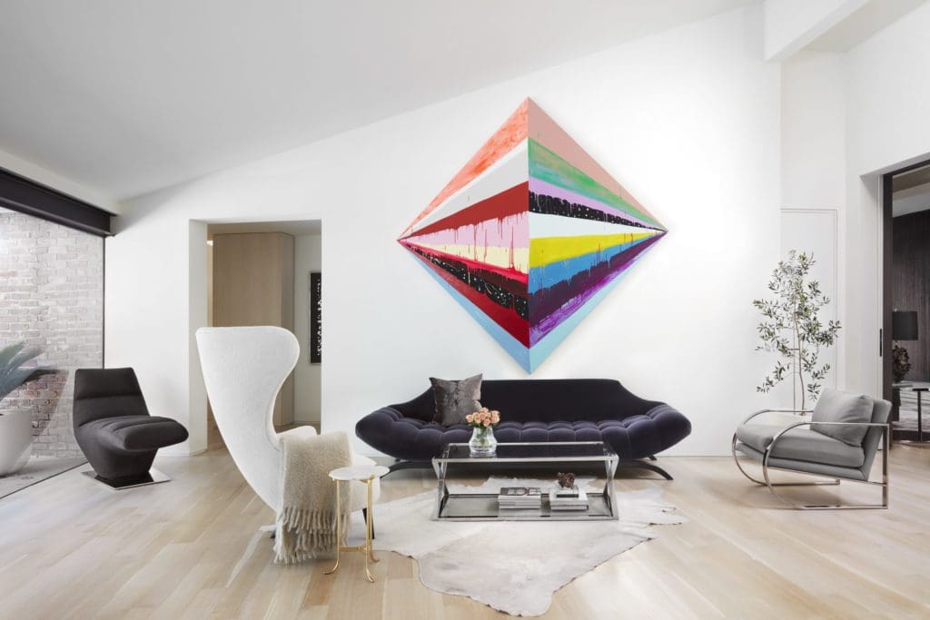 Maya Hayuk’s Bonfire, Part 1, 2012, dominates a wall in the living room. Sofa from Emily Summers Studio. Vintage Milo Baughman chair. Tom Dixon wingback chair. Mecox side table. Circa-1960 chaise from Again & Again.