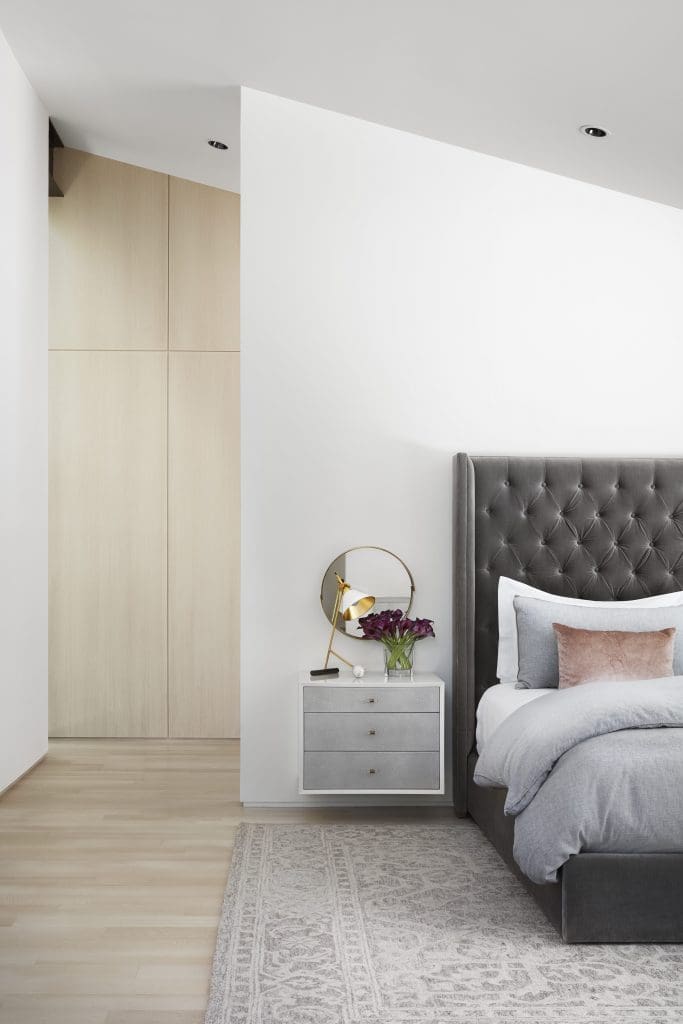 In the master bedroom, floating night tables by R Brant Design in shagreen and lacquer. Kelly Wearstler mirror and lamp. Restoration Hardware bed. Loloi rug. 