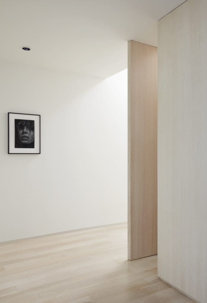 Massive pivoting white oak door designed by Joshua Nimmo separates the master wing. Richard Phillips’ Kenza, 2015.