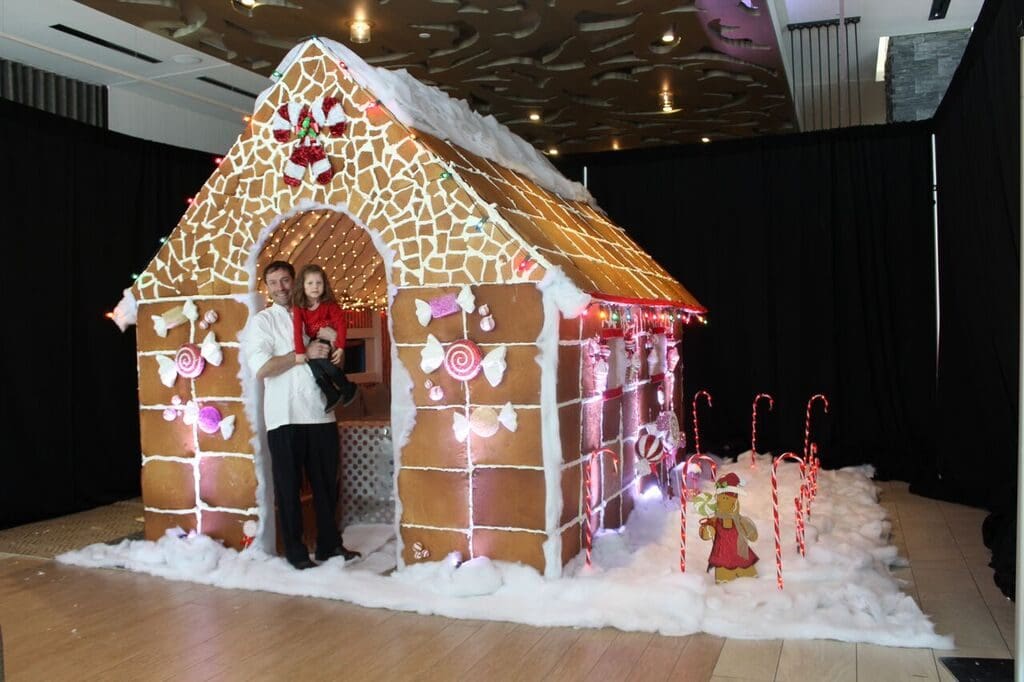 Stella San Jac chef Martin Wilda enjoys a moment in the giant gingerbread house.