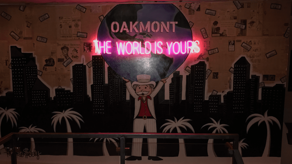 The venue features several pieces of Mr. Moneybag artwork, tying in The Wolf of Wall Street  theme. 