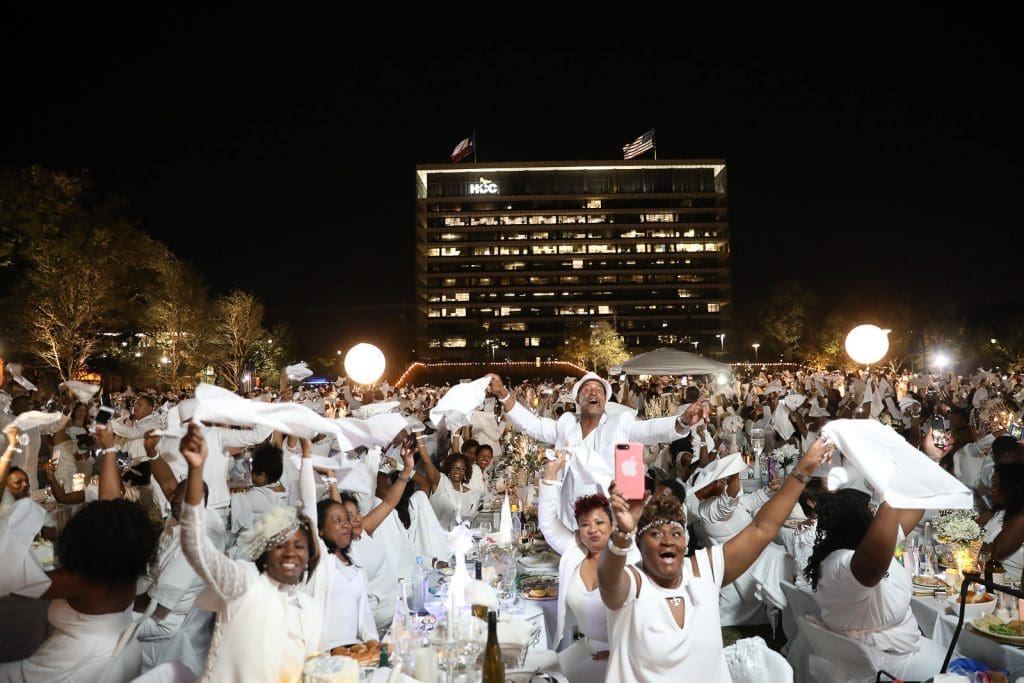 Traditional Le Dîner en Blanc napkin wave to commence dinner