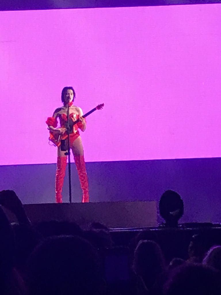 Indie artist St. Vincent played guitar against a chamber rock recording. 