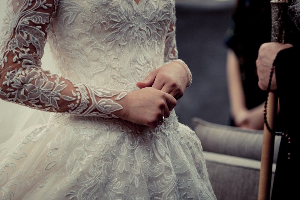 The bride wore a Ysa Makino lace gown from Mia Bridal, with a long-sleeved lace overlay for the reception.