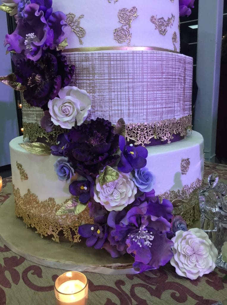 Swaths of peonies, roses and orchids made from icing circle the seven-tiered cake.