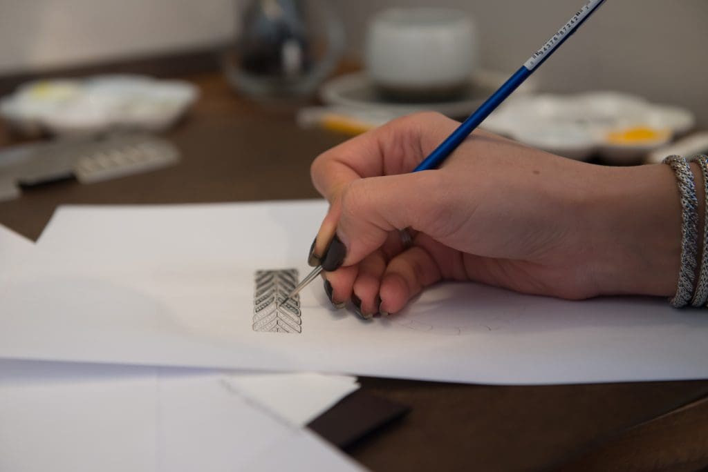 Detail of a John Hardy artist creating a design.