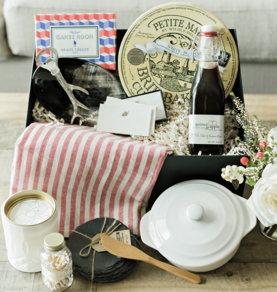 The Mostess Hearth Fall Box is filled with items like a brie baker, a fun card game, slate coasters, tart cherry syrup filled with cocktail recipes and entertainment ideas. 