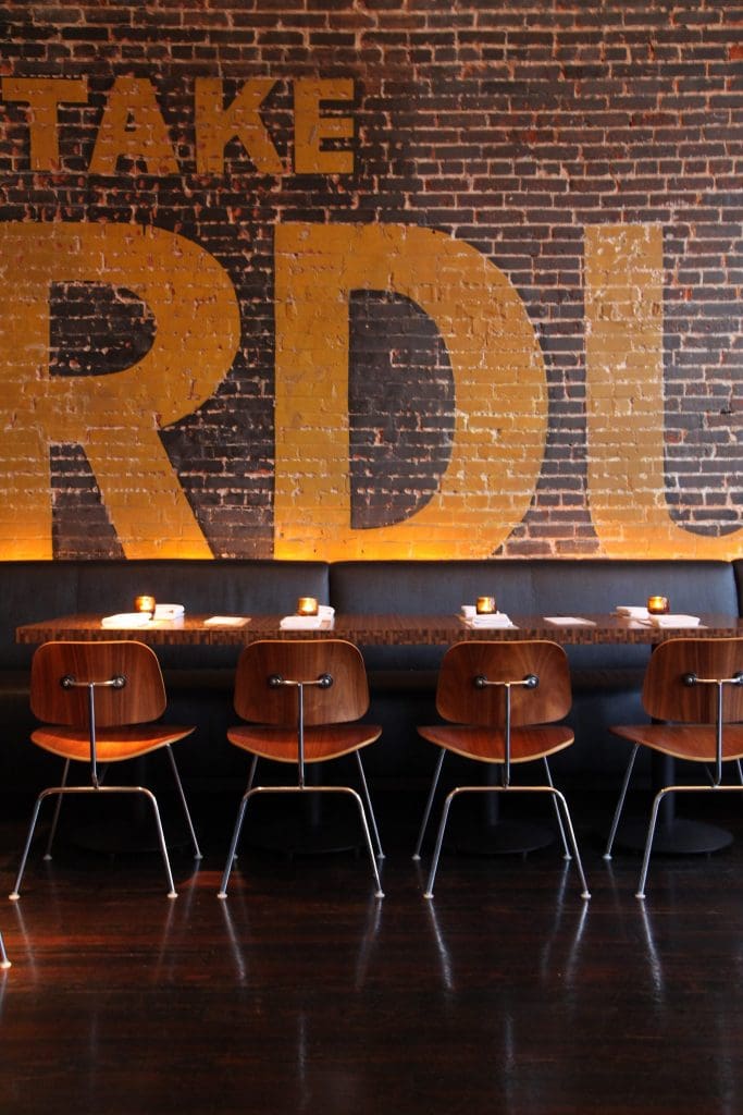 Exposed brick walls and hardwood floors are original to the 1908 building that houses Local