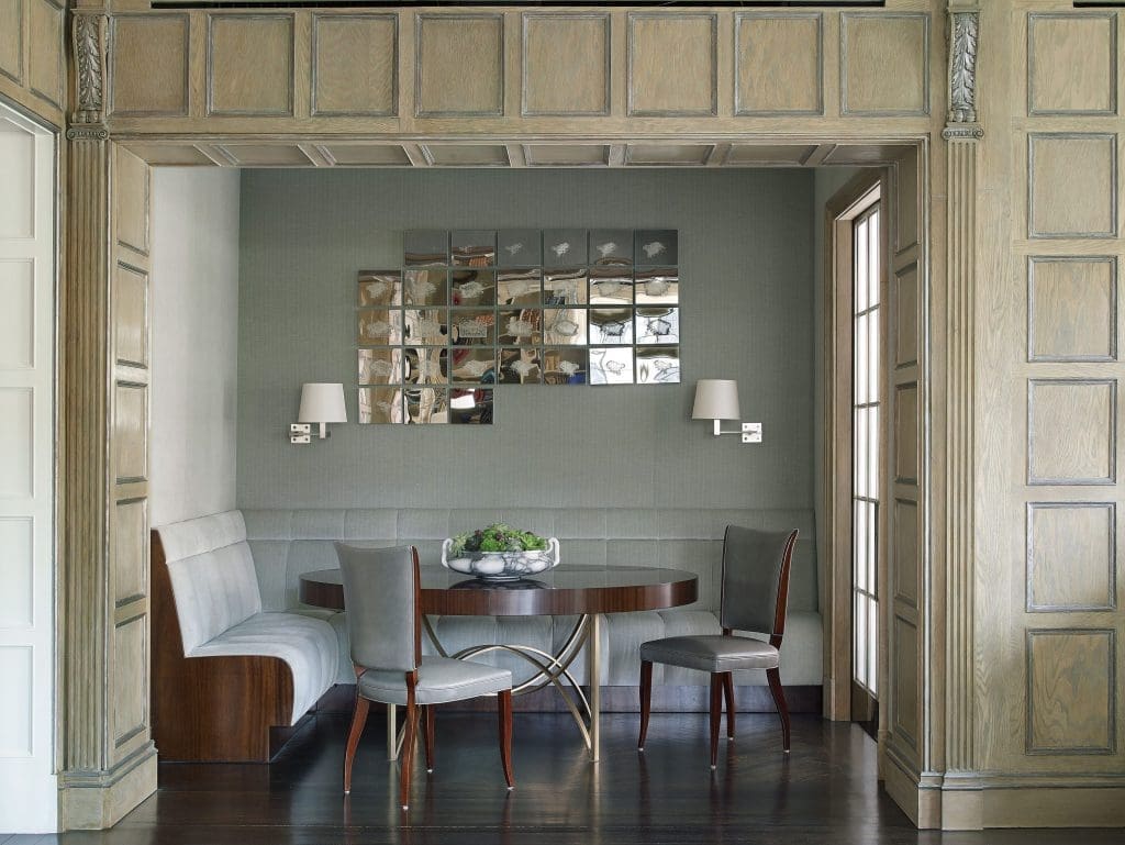 In the dining room, walls are upholstered in Pollock's strié velvet. Custom banquette. Client's own Art Deco chairs. Custom mahogany and silver-leaf table. Maison Charles sconces. Teresita Fernandez’s 30 Dissolves, 2011.