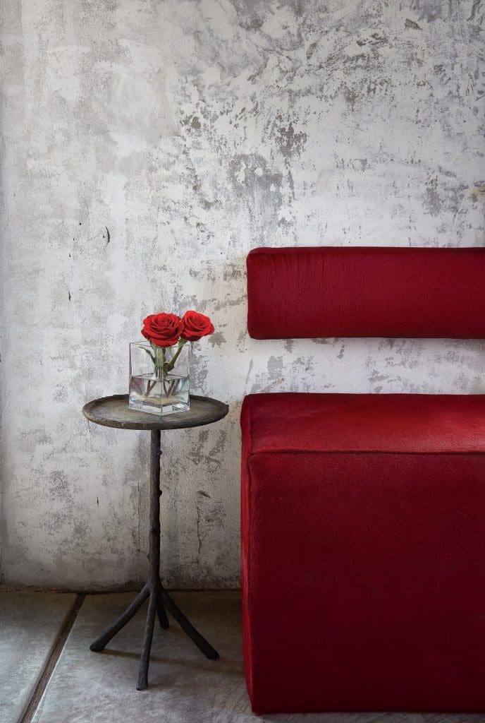 Custom bench with Cortina hide from George Cameron Nash. Vintage iron table. The plaster walls were patched, leaving the old patina. 