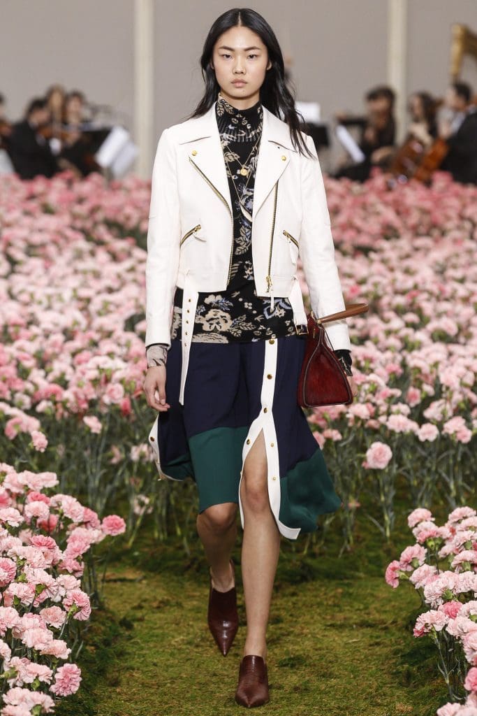 Tory Burch "Happy Times" pattern merino wool sweater, viscose crepe skirt, and white leather moto jacket.