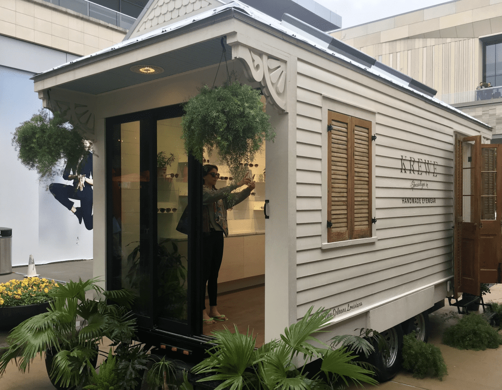 The KREWE Tiny House is a mobile shopping experience inspired by New Orleans' iconic shotgun houses. 